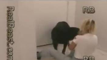 Blonde getting banged by a black dog on all fours