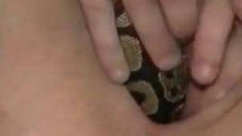 Relaxed chick uses snake's tail instead of usual sex toys