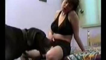 Curious dog nicely licks pretty mistress between her legs