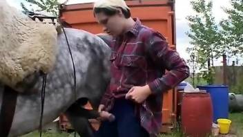 Skinny lady worships a huge animal cock outdoors